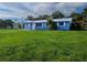 Charming blue home with a well-maintained lawn and mature trees at 1200 Ne 45Th Pl, Ocala, FL 34479