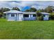Charming one-story home with a freshly painted exterior, a well-manicured lawn, and decorative trim at 1200 Ne 45Th Pl, Ocala, FL 34479