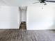 Hallway with sleek gray wood-look flooring and access to multiple rooms at 1200 Ne 45Th Pl, Ocala, FL 34479