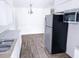Bright kitchen with stainless steel refrigerator, gray countertops, and white cabinets offering ample workspace at 1200 Ne 45Th Pl, Ocala, FL 34479