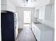 Bright kitchen with white cabinets, modern appliances, and gray countertops, perfect for cooking at 1200 Ne 45Th Pl, Ocala, FL 34479