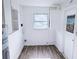 Clean laundry room with modern appliances, neutral color palette, and storage solutions for convenience at 1200 Ne 45Th Pl, Ocala, FL 34479