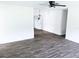 Bright living room featuring modern ceiling fan and stylish gray wood-look flooring at 1200 Ne 45Th Pl, Ocala, FL 34479