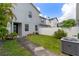 Well-manicured backyard area is fenced, featuring mature plants and a patio at 1615 Wilson Ave, Orlando, FL 32804