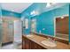 Bright bathroom with a double vanity, tiled shower, and blue walls at 1615 Wilson Ave, Orlando, FL 32804