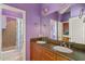 Double sink bathroom featuring granite counters and an open shower/tub at 1615 Wilson Ave, Orlando, FL 32804