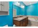 Bathroom featuring double vanity, large mirror, and soaking tub at 1615 Wilson Ave, Orlando, FL 32804