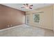 Spacious bedroom with ceiling fan, neutral carpeting, and outdoor access at 1615 Wilson Ave, Orlando, FL 32804
