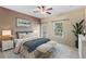 Staged bedroom with ceiling fan, neutral carpeting, and outdoor access at 1615 Wilson Ave, Orlando, FL 32804