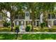 Charming two-story home with a walkway leading to the front door and mature trees in the front yard at 1615 Wilson Ave, Orlando, FL 32804