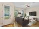 Staged living room featuring hardwood floors, a gray couch and television for relaxation and enjoyment at 1615 Wilson Ave, Orlando, FL 32804