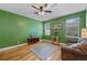 Cozy living room with hardwood floors, ceiling fan, and a comfortable sofa at 1615 Wilson Ave, Orlando, FL 32804