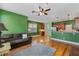 Bright living room with hardwood floors, ceiling fan, and a comfortable sofa at 1615 Wilson Ave, Orlando, FL 32804
