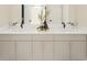 Bathroom featuring double sink vanity, neutral cabinets, quartz countertops, and modern fixtures at 1896 Seawall Way, Celebration, FL 34747