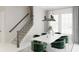 Bright dining room with table, stylish chairs, modern lighting, and stairs at 1896 Seawall Way, Celebration, FL 34747