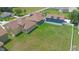 An aerial view of a residential home featuring a spacious backyard with lush green grass at 1919 Sipes Ave, Sanford, FL 32771
