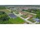 An aerial shot features a neighborhood with suburban homes located near a serene lake and lush trees at 1919 Sipes Ave, Sanford, FL 32771