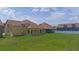 Expansive backyard view showcasing green lawn and covered patio perfect for outdoor entertaining at 1919 Sipes Ave, Sanford, FL 32771