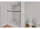 Bright bathroom features a tiled shower with decorative stripe and a modern toilet at 1919 Sipes Ave, Sanford, FL 32771