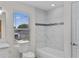 Bathroom featuring marble-style walls, a soaking tub, and a single window at 1919 Sipes Ave, Sanford, FL 32771