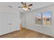 A bright, empty bedroom featuring hardwood floors, a double closet, and a window at 1919 Sipes Ave, Sanford, FL 32771