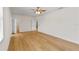 A spacious, bright bedroom with hardwood floors, a ceiling fan, and access to a walk-in closet at 1919 Sipes Ave, Sanford, FL 32771
