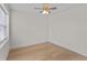 A bright, empty bedroom featuring hardwood floors and a ceiling fan at 1919 Sipes Ave, Sanford, FL 32771