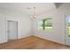 Bright dining room with hardwood floors, modern chandelier, and a large window at 1919 Sipes Ave, Sanford, FL 32771