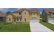 Charming two-story home with a lush green lawn and attached two-car garage at 1919 Sipes Ave, Sanford, FL 32771