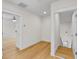 Hallway featuring hardwood floors, white walls, and view of other room at 1919 Sipes Ave, Sanford, FL 32771