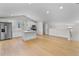 Open kitchen with white cabinets, stainless steel appliances, and hardwood floors at 1919 Sipes Ave, Sanford, FL 32771