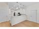 Stylish kitchen with white cabinetry, stainless steel appliances, and modern pendant lighting at 1919 Sipes Ave, Sanford, FL 32771