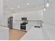 Modern kitchen with white cabinets, stainless steel appliances, and quartz countertops at 1919 Sipes Ave, Sanford, FL 32771