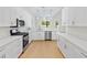 Updated kitchen with white cabinets, stainless steel appliances, and modern lighting at 1919 Sipes Ave, Sanford, FL 32771