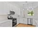 Modern kitchen featuring white cabinets, stainless steel appliances, and a stylish pendant lights at 1919 Sipes Ave, Sanford, FL 32771