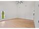 Bright, open living room with a modern ceiling fan and hardwood flooring at 1919 Sipes Ave, Sanford, FL 32771