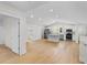 Bright open-concept living space with hardwood floors seamlessly flowing into the modern kitchen at 1919 Sipes Ave, Sanford, FL 32771