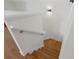 A well-lit wooden staircase with white railing at 1919 Sipes Ave, Sanford, FL 32771