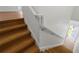 A well-lit wooden staircase with white railing at 1919 Sipes Ave, Sanford, FL 32771