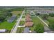 Aerial view of new homes and neighborhood street in a well-planned community with mature trees at 1929 Sipes Ave, Sanford, FL 32771
