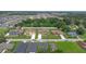 Aerial view of new homes and neighborhood street in a well-planned community with mature trees at 1929 Sipes Ave, Sanford, FL 32771