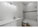 Bathroom featuring a white vanity, tiled walls, and shower-tub combo at 1929 Sipes Ave, Sanford, FL 32771