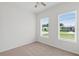 Light-filled bedroom with neutral carpet and double windows at 1929 Sipes Ave, Sanford, FL 32771