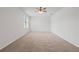 Large bedroom featuring neutral carpet, a ceiling fan and a large window at 1929 Sipes Ave, Sanford, FL 32771