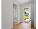 Bright foyer with hardwood floors, white walls, and an open door leading to the exterior at 1929 Sipes Ave, Sanford, FL 32771