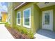 Home entrance with landscaped garden and a bright white door with glass features at 1929 Sipes Ave, Sanford, FL 32771
