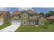 Well maintained home with lush green lawn, driveway, and mature shrubbery at 1929 Sipes Ave, Sanford, FL 32771