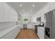 Bright kitchen featuring white cabinets, stainless steel appliances, and hardwood flooring at 1929 Sipes Ave, Sanford, FL 32771
