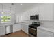 Modern kitchen with white cabinetry, stainless steel appliances, and plenty of counter space at 1929 Sipes Ave, Sanford, FL 32771