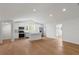 Open floor plan featuring a kitchen with island, wood floors and white walls at 1929 Sipes Ave, Sanford, FL 32771